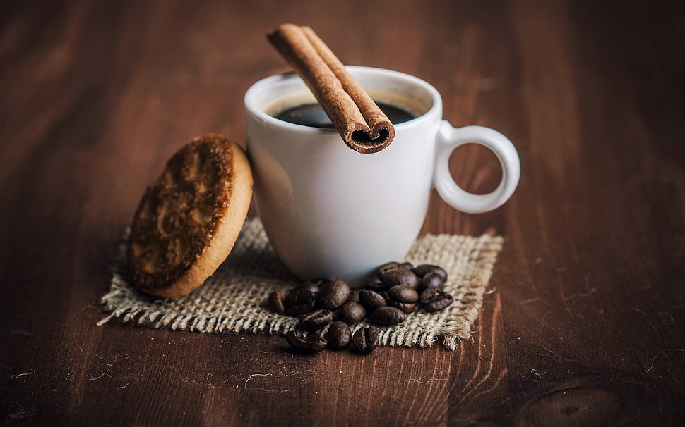 white ceramic mug, coffee beans, and brown cookie on brown wooden surface HD wallpaper