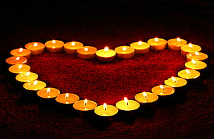 tea light candles with fire forming a heart shape HD wallpaper