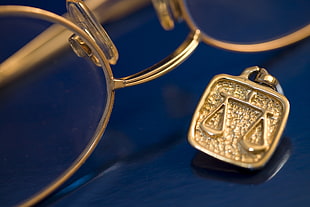 gold-colored frame eyeglasses and jewelry
