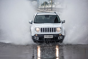 white Jeep sport utility vehicle covered with water
