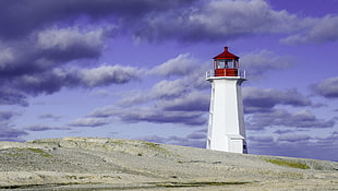 white and red lighthouse near gray sand during daytime HD wallpaper