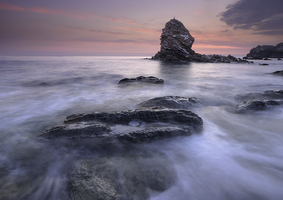 sea waves and rock formations during golden hours HD wallpaper