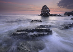 sea waves and rock formations during golden hours