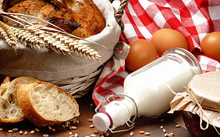clear glass milk bottle and brown bread