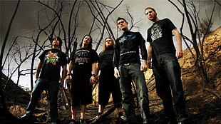 five men in black t-shirt standing near baretrees