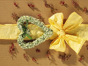 closeup photo of heart-shaped floral decor and yellow bow