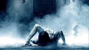 woman on floor near door horror movie