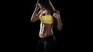 woman in yellow sports bra and black bottoms