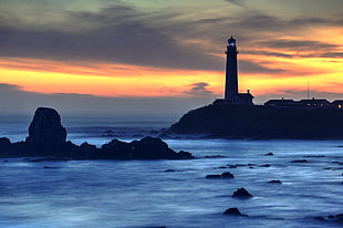silhouette of lighthouse during sunset HD wallpaper