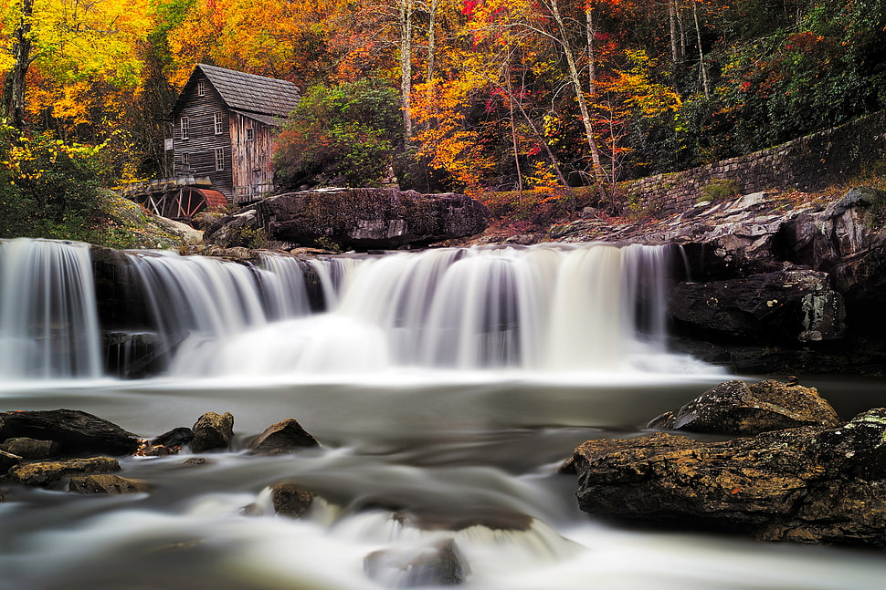 timelapse photography of waterfalls near brown wooden house HD wallpaper