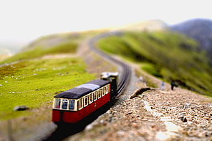 tilt shift photo of red and black train plastic toy, snowdon