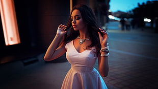 woman in white sleeveless dress posing for photo
