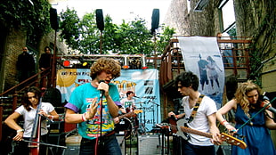 5 member band playing instrument during daytime