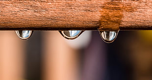 water drop on brown wooden surface