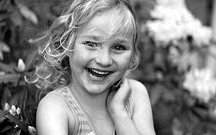 grayscale photo of a toddler girl wearing sleeveless shirt