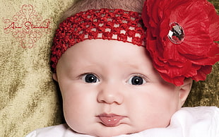baby wearing red knit headdress