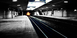 black and white wooden table, lights, subway, train station, selective coloring