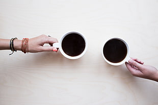 two people holding white coffee mugs HD wallpaper