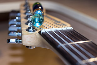closeup photo of marble on guitar headstock