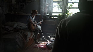 woman playing guitar sitting on her bed