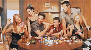 three men and three women surrounded brown wooden table with poker chips