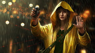 woman in yellow raincoat with green sling bag