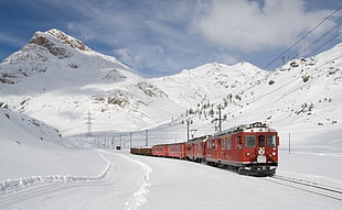 red and brown train on railing on snow-filled mountains HD wallpaper