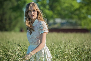 woman in dress on green grassy field
