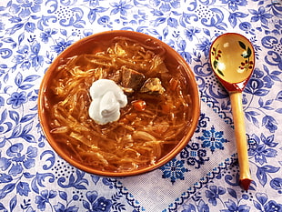 brown noodle dish on ceramic bowl