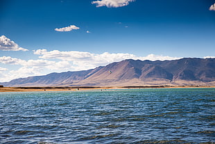 landscape photography of body of water near mountains