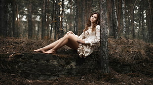 photography of woman resting in forest