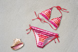 pair of multicolored tie-dyed bikini and shell