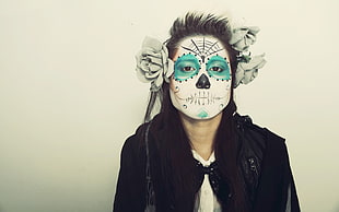 person with white and blue face skull paint