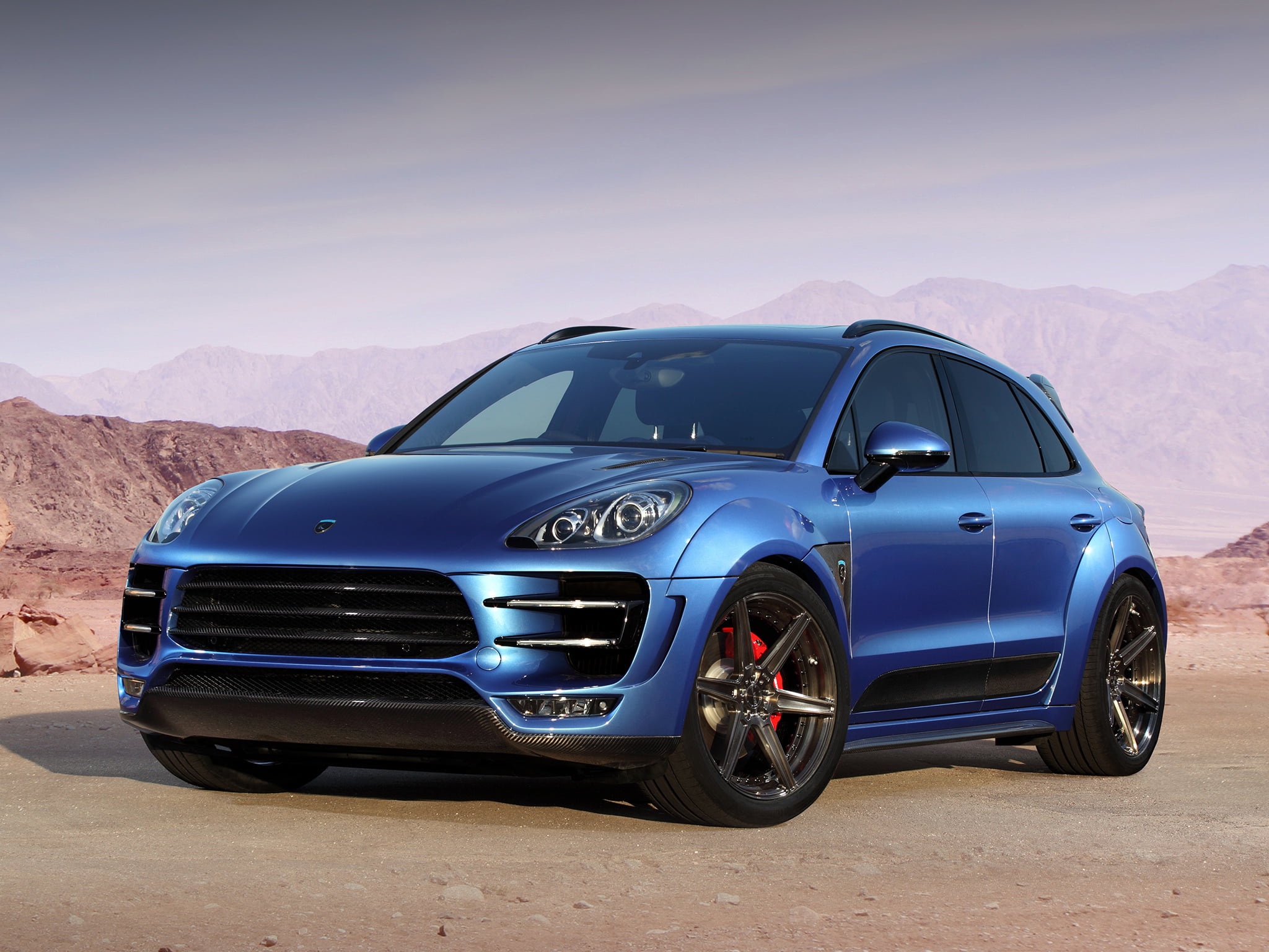 blue Porsche Macan on dessert