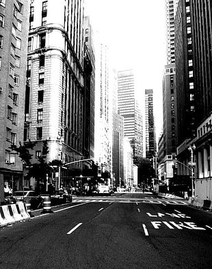 grayscale photo high-rise buildings and road