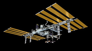 silver and gold satellite flying on mid air