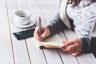 woman writing something on a notebook HD wallpaper