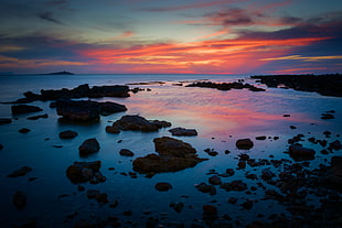 photo of rocky shore during sunset HD wallpaper