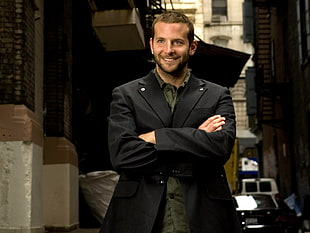 man in black notch lapel suit jacket in alleyway