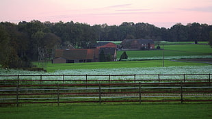 landscape photo of barn house surrounded by grass