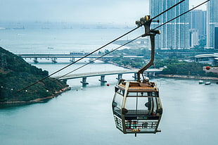 brown and black cable cart near bridge during daytime
