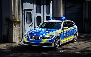blue and white BMW police car sedan