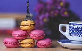 brown and pink cooked pastry with Eiffel tower on top near white and blue ceramic mug with saucer HD wallpaper