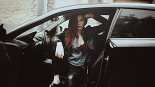 woman wearing black leather jacket in car
