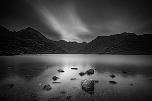 grayscale photograph of a mountain and body of water, loch coruisk