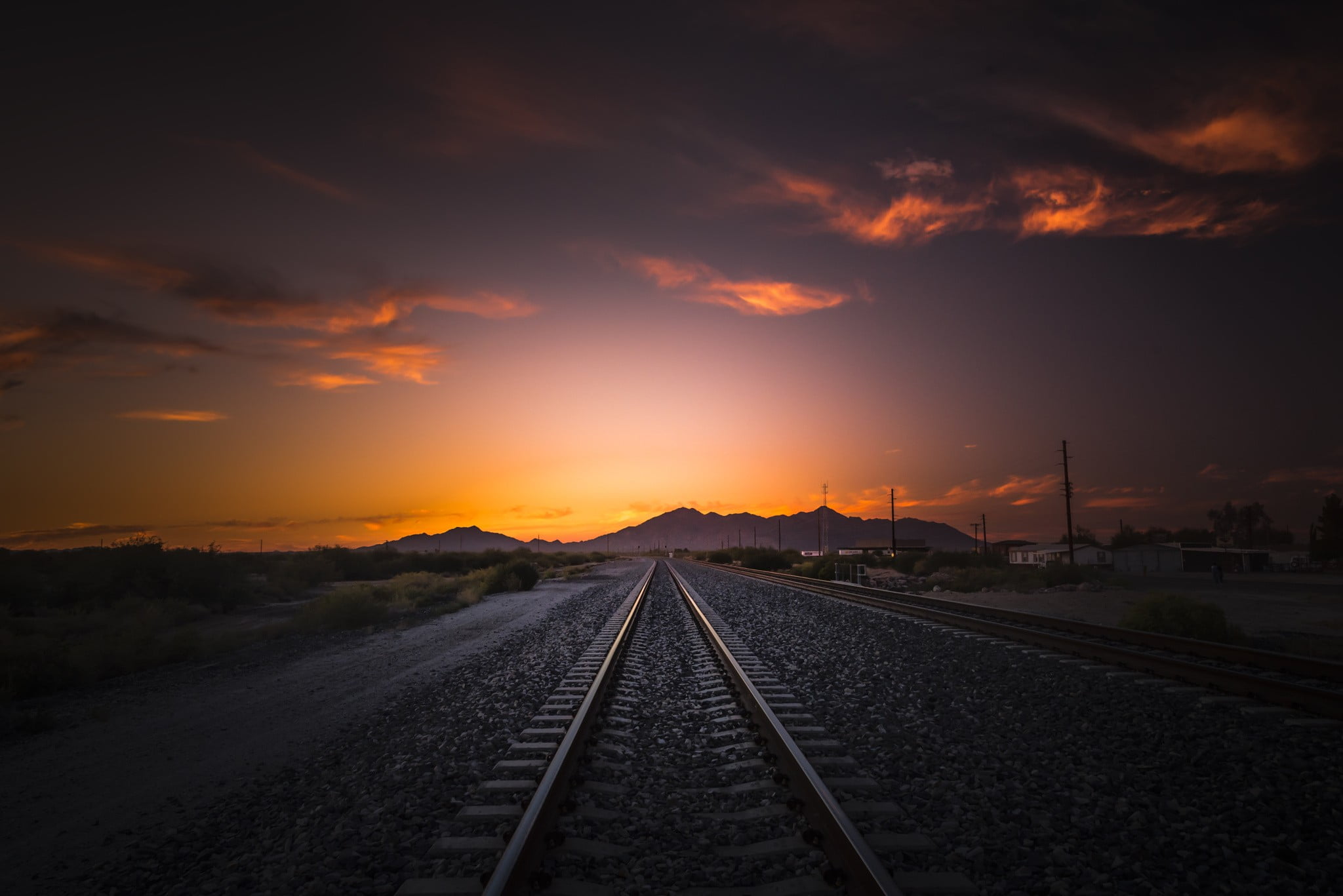 grey metal train rail during dawn
