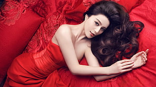 woman wearing red strapless dress lying on red cushion HD wallpaper