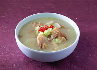 close up photo of broth soup filled white bowl