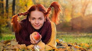 selective focus photography of woman holding apple