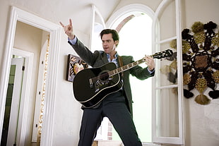 Jim Carrey holding  acoustic guitar HD wallpaper